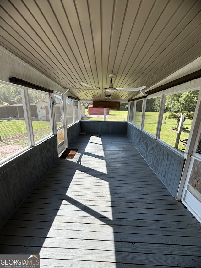 unfurnished sunroom with wood ceiling, a wealth of natural light, and lofted ceiling