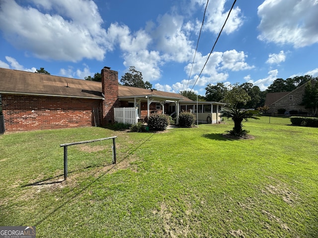 back of property with a lawn