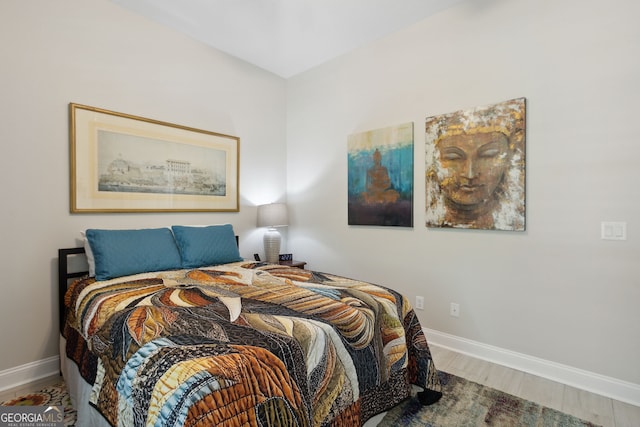 bedroom featuring baseboards and wood finished floors