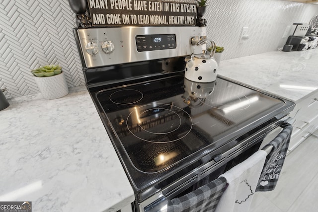 details with light stone counters and stainless steel electric stove