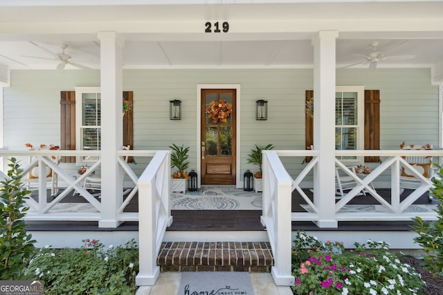 view of exterior entry featuring ceiling fan and covered porch