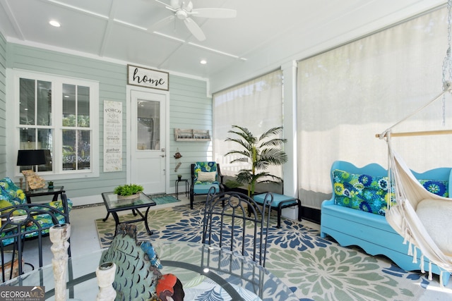 sunroom / solarium featuring ceiling fan