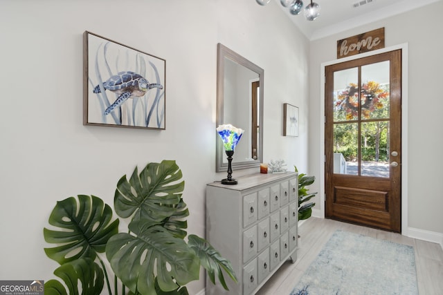 foyer featuring baseboards and visible vents