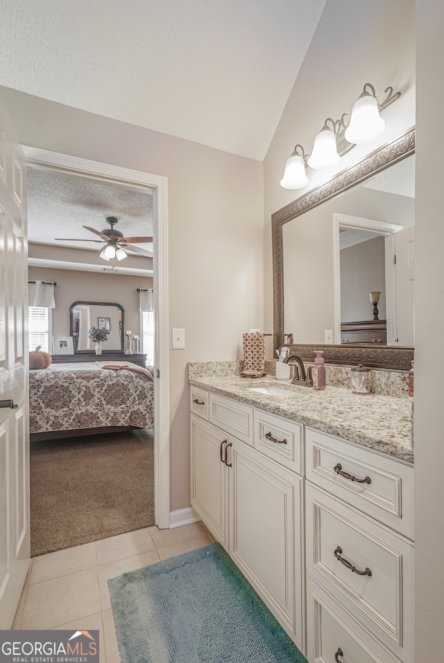 bathroom featuring a textured ceiling, tile patterned flooring, vanity, and ceiling fan