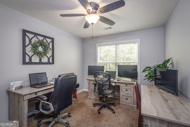 office area with ceiling fan, carpet floors, and a textured ceiling