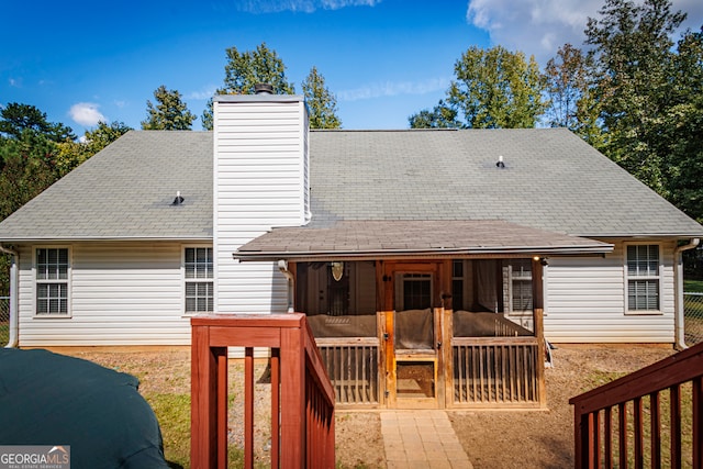 rear view of property featuring a deck