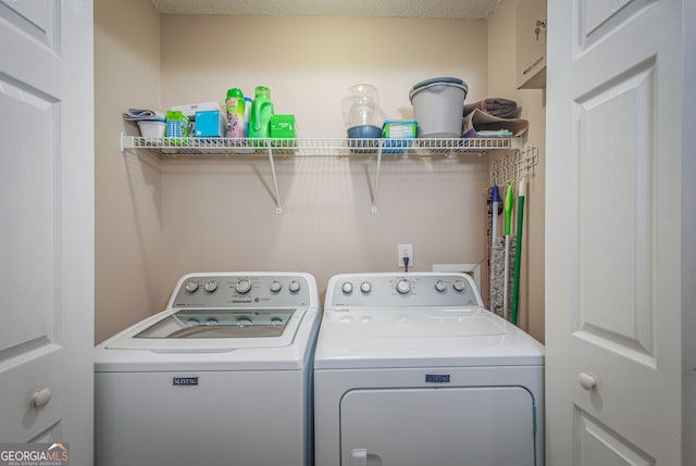 washroom featuring a textured ceiling and washer and dryer