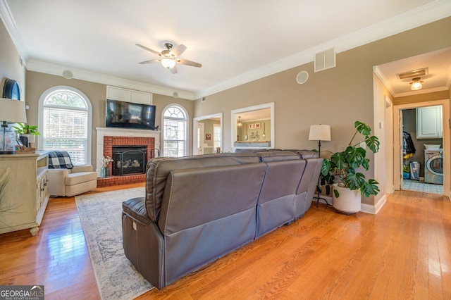 living room featuring light hardwood / wood-style floors, a fireplace, and a wealth of natural light