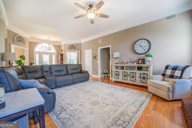 living room featuring ceiling fan, crown molding, and hardwood / wood-style floors