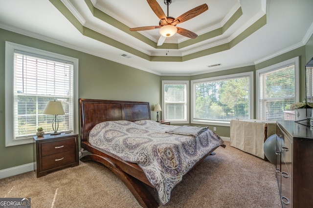 bedroom featuring crown molding, ceiling fan, light carpet, and a raised ceiling