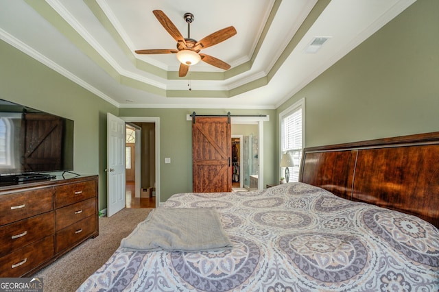 bedroom with light carpet, ceiling fan, ornamental molding, and a barn door