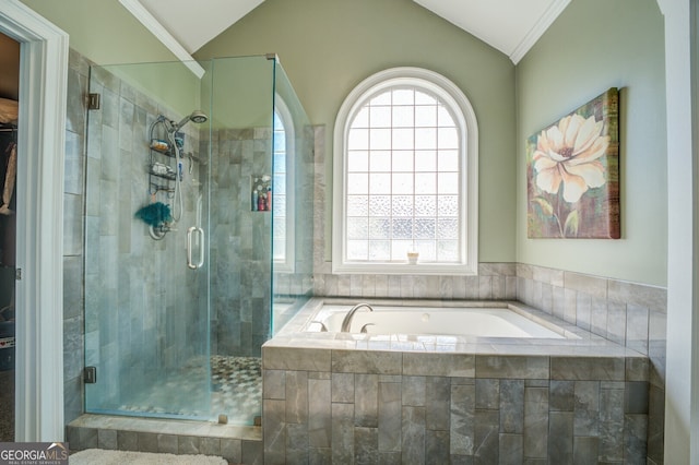 bathroom with shower with separate bathtub, vaulted ceiling, and a wealth of natural light