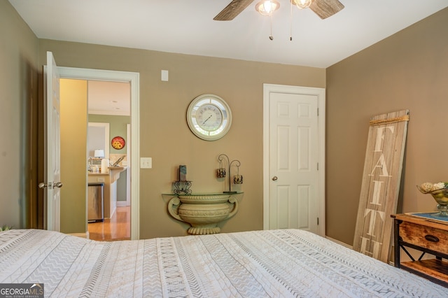 bedroom featuring ornamental molding, light hardwood / wood-style floors, and ceiling fan