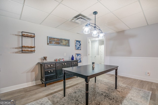 office area featuring a paneled ceiling and light hardwood / wood-style floors