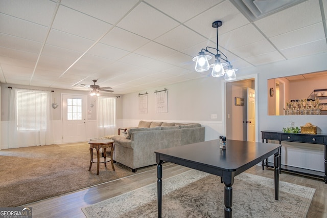 interior space featuring ceiling fan, hardwood / wood-style flooring, and a drop ceiling