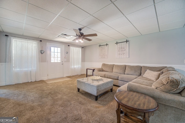 carpeted living room with a paneled ceiling and ceiling fan