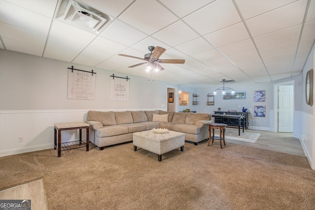 living room featuring a paneled ceiling, light carpet, and ceiling fan