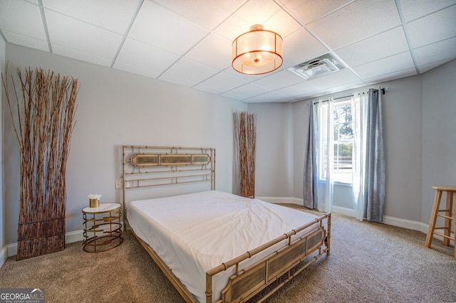 bedroom featuring carpet and a drop ceiling