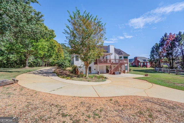 exterior space featuring a front yard and cooling unit