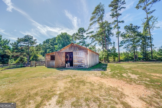 view of yard featuring a rural view and an outbuilding