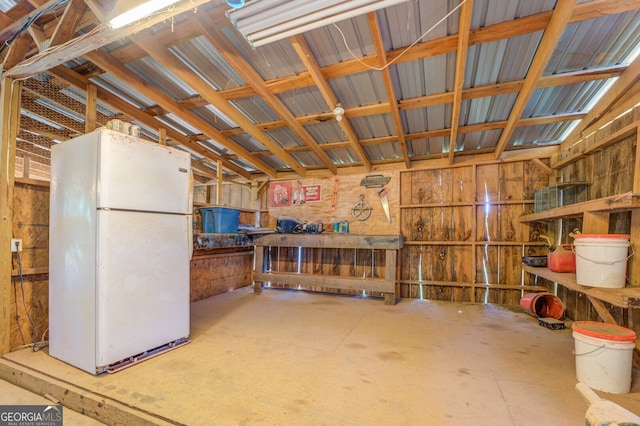 miscellaneous room with lofted ceiling and a workshop area