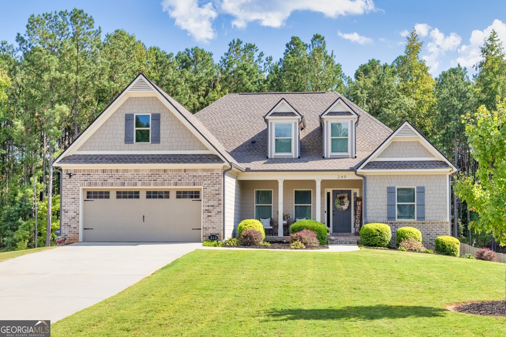 view of front of property with a garage and a front lawn