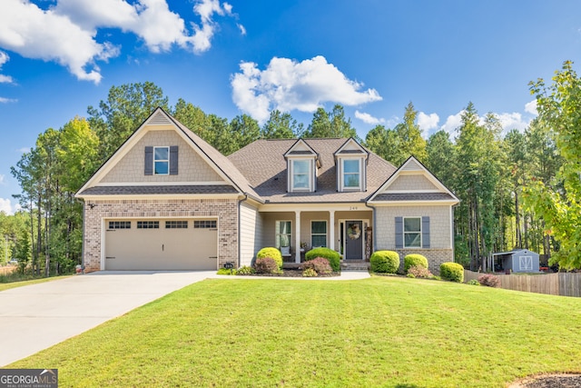 craftsman-style house featuring a garage, a front lawn, and covered porch