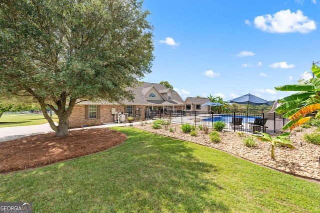 view of yard with a fenced in pool