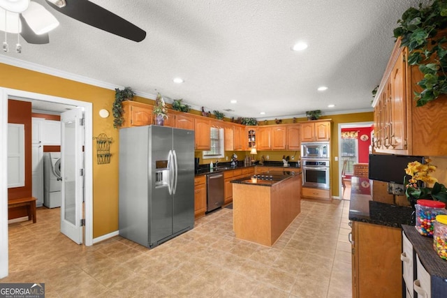 kitchen featuring stainless steel appliances, ceiling fan, a center island, and crown molding