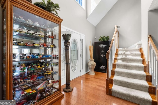 375 Dasher St, Lyons, GA 30436 - foyer with stairway, visible vents, a high ceiling, and wood finished floors