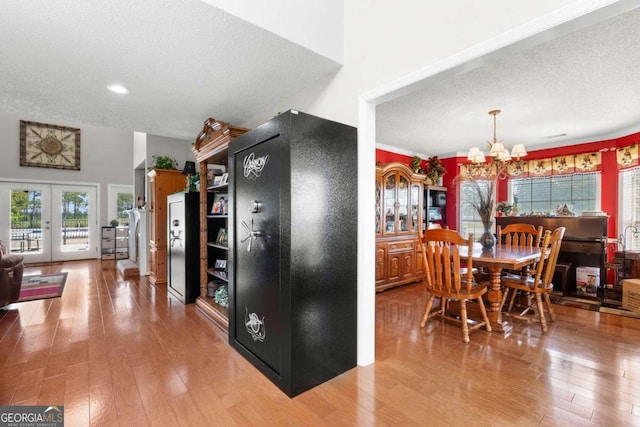 375 Dasher St, Lyons, GA 30436 - dining area featuring light wood-style floors, a textured ceiling, recessed lighting, french doors, and a notable chandelier
