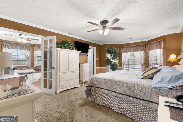 carpeted bedroom featuring ceiling fan, a textured ceiling, and crown molding