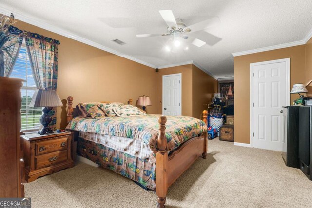 bedroom with a textured ceiling, crown molding, light carpet, and ceiling fan