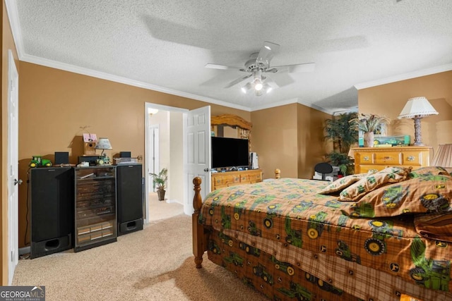 carpeted bedroom with a textured ceiling, ornamental molding, and ceiling fan