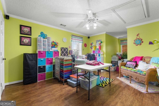 interior space featuring ceiling fan, a textured ceiling, dark hardwood / wood-style floors, and crown molding