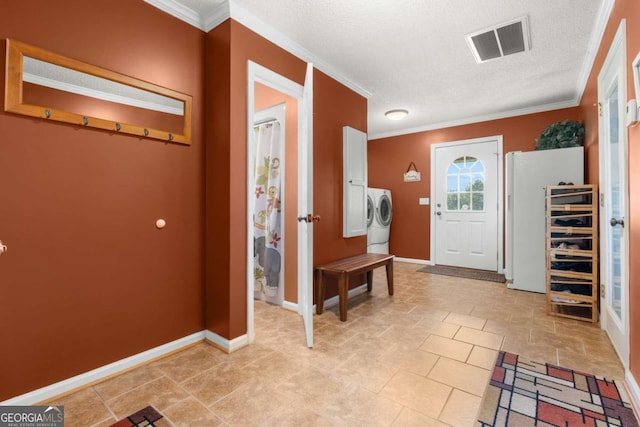 foyer entrance with a textured ceiling and crown molding