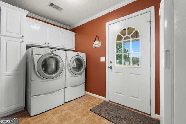 375 Dasher St, Lyons, GA 30436 - laundry area featuring a textured ceiling, ornamental molding, visible vents, washing machine and dryer, and cabinet space