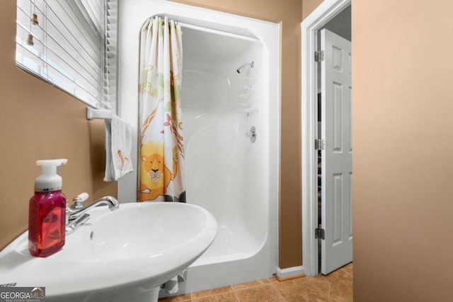 375 Dasher St, Lyons, GA 30436 - bathroom with a shower with shower curtain, a sink, and tile patterned flooring