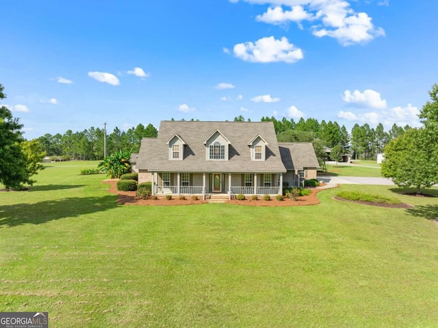 new england style home featuring a front lawn and covered porch