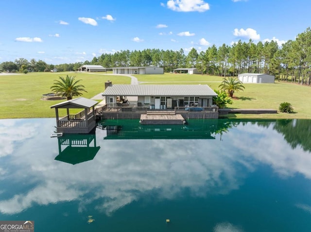 exterior space featuring a lawn and a water view