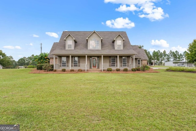 375 Dasher St, Lyons, GA 30436 - cape cod-style house featuring a front yard, covered porch, and roof with shingles