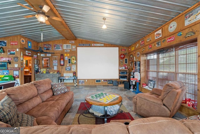 living room with vaulted ceiling with beams, wood walls, and ceiling fan