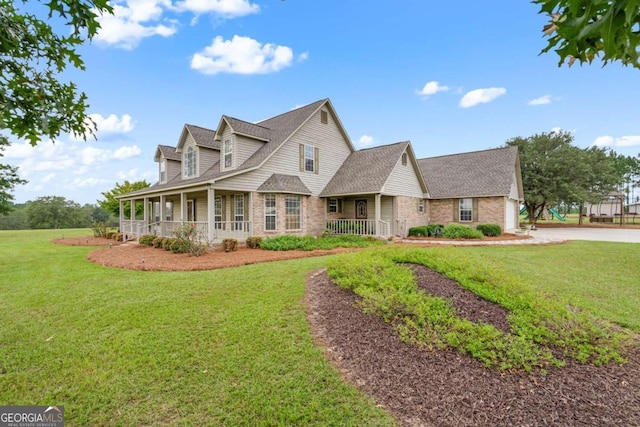 375 Dasher St, Lyons, GA 30436 - cape cod-style house featuring concrete driveway, a front yard, brick siding, a shingled roof, and covered porch