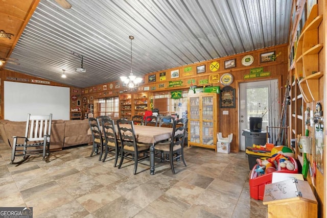 375 Dasher St, Lyons, GA 30436 - dining room featuring stone finish flooring, wooden walls, and lofted ceiling