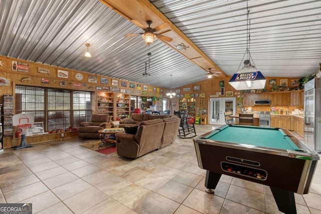 rec room with lofted ceiling with beams, wood walls, light tile patterned floors, billiards, and ceiling fan