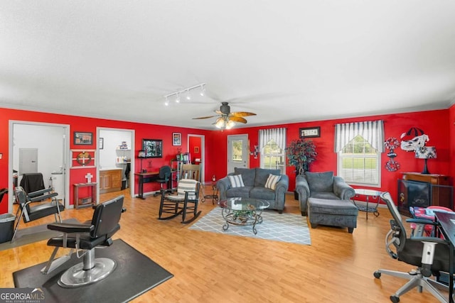 living room featuring ornamental molding, hardwood / wood-style floors, and ceiling fan