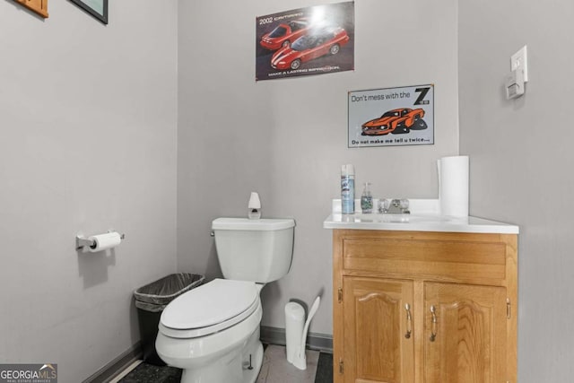 bathroom with tile patterned flooring, vanity, and toilet