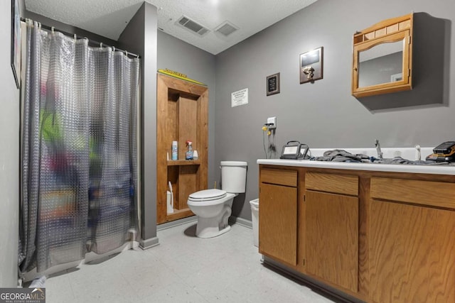 bathroom with walk in shower, vanity, toilet, and a textured ceiling