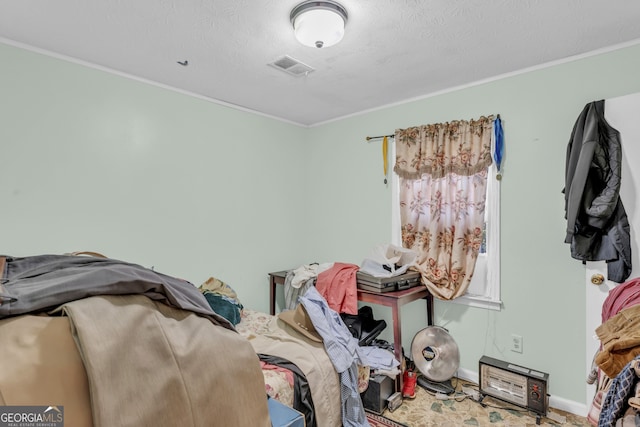 carpeted bedroom with ornamental molding and a textured ceiling