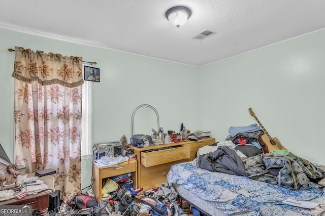 bedroom with ornamental molding and a textured ceiling